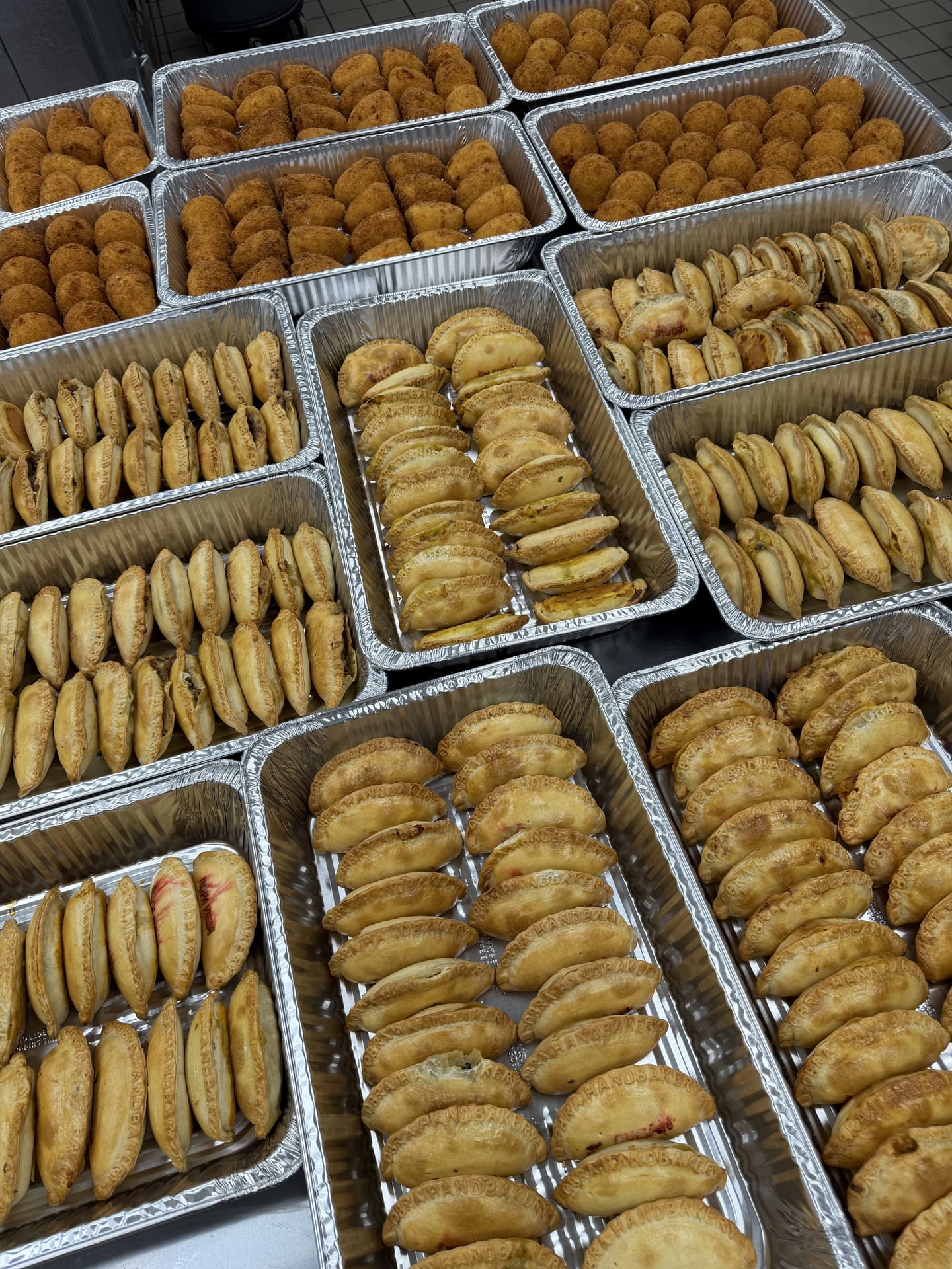 Trays of golden baked empanadas