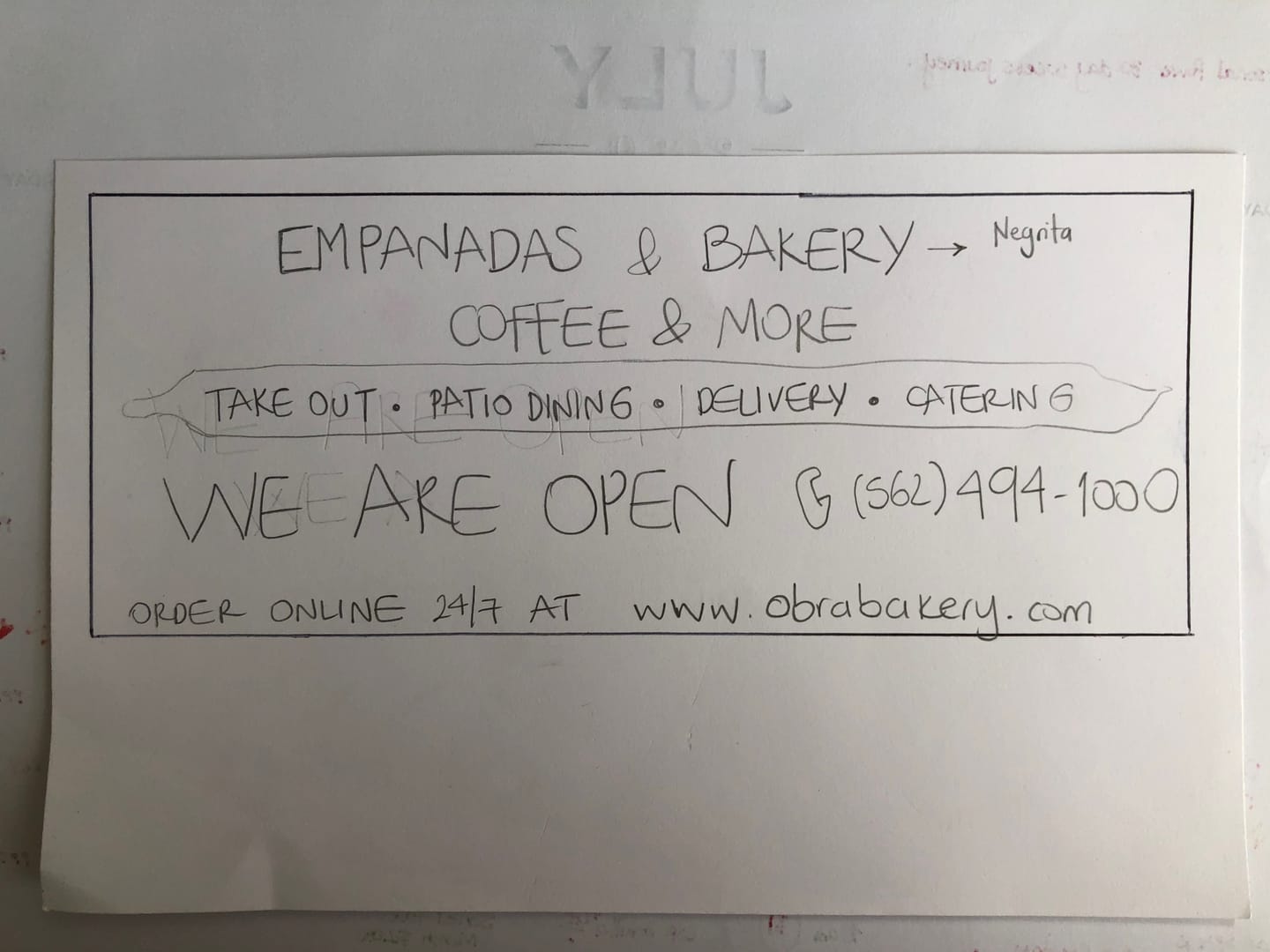Handwritten sign listing empanadas, Nutella and coffee